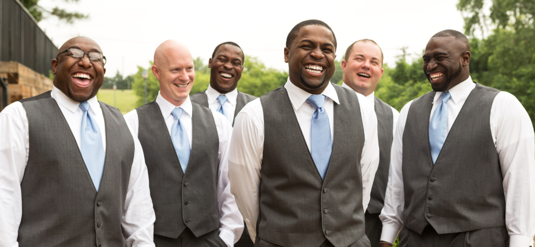 Group of groomsmen smiling