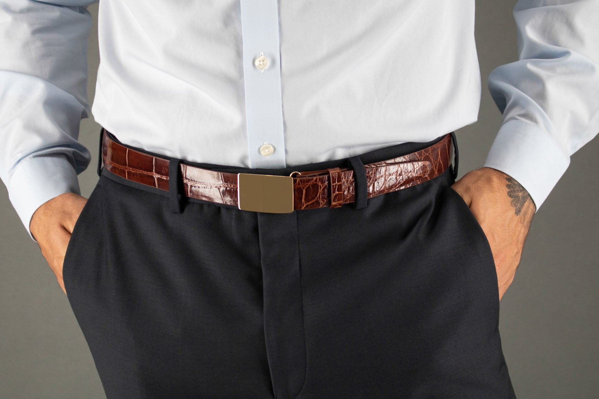 Close up image of an exotic leather belt with a gold buckle