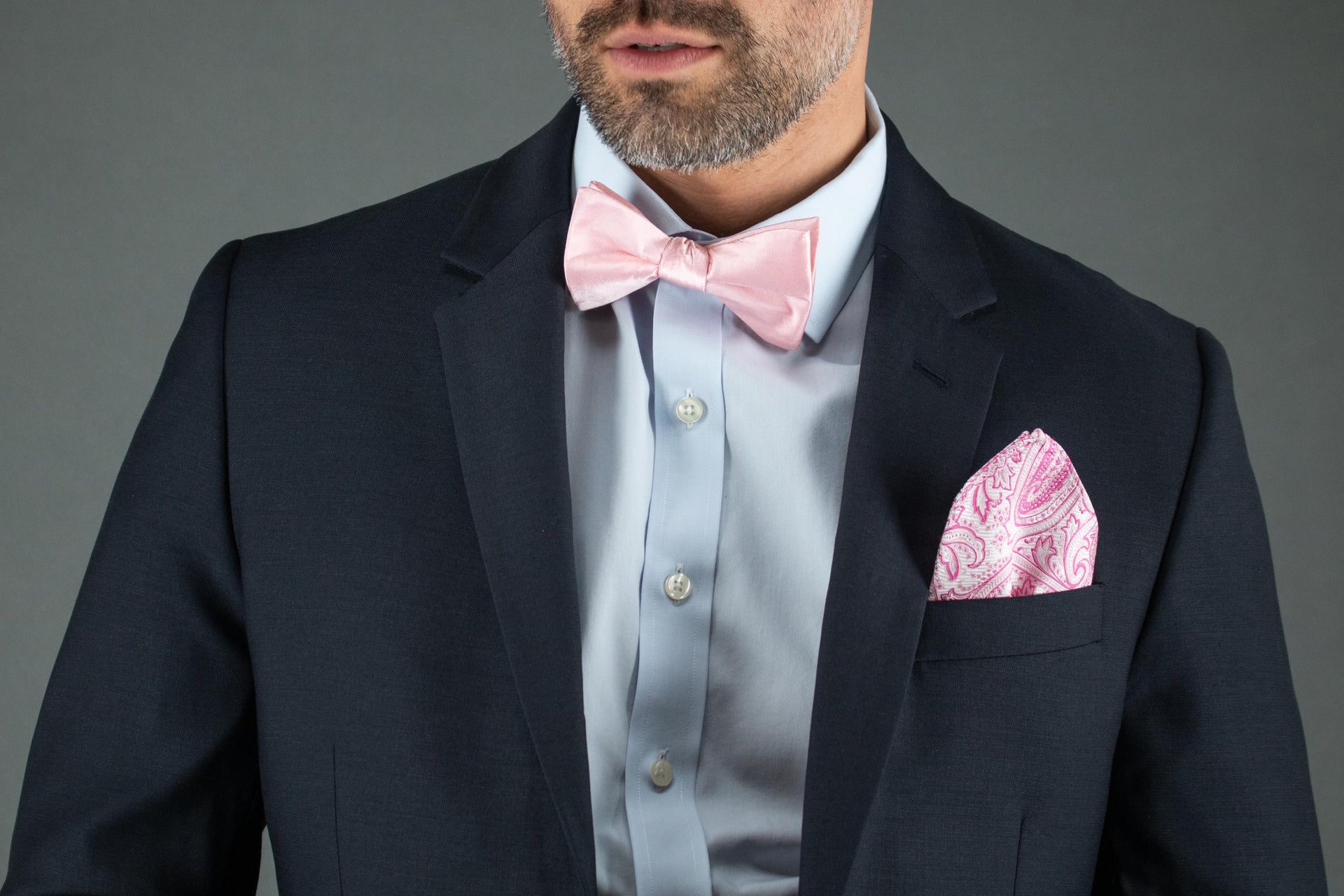 Man wearing pink bow tie and pocket square