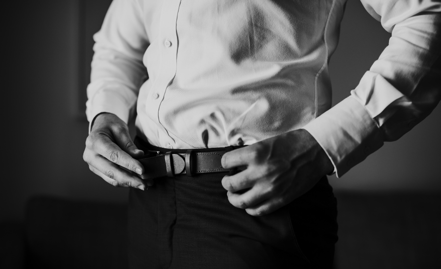 Man buckling his belt