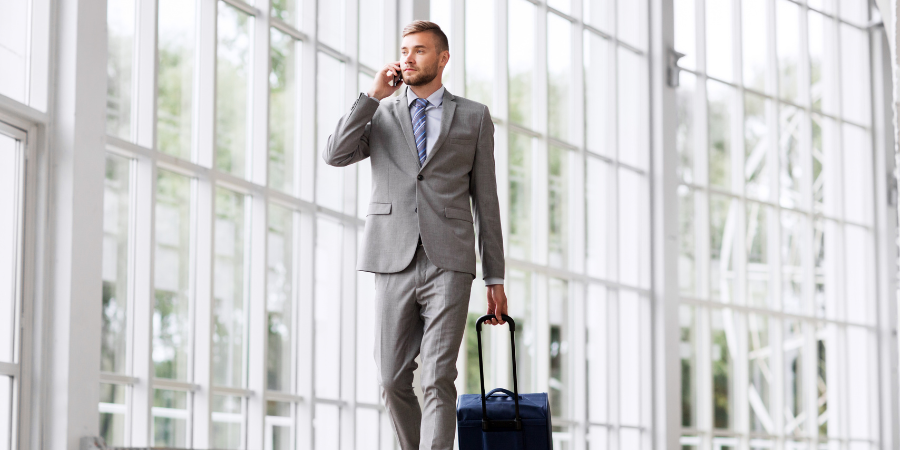 Business man talking on phone in airport