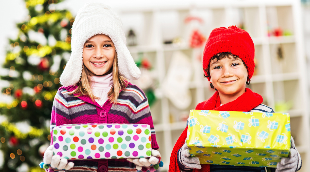 Girl and boy holding Christmas presents