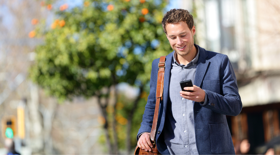 Businessman wearing a suit and walking while on his phone