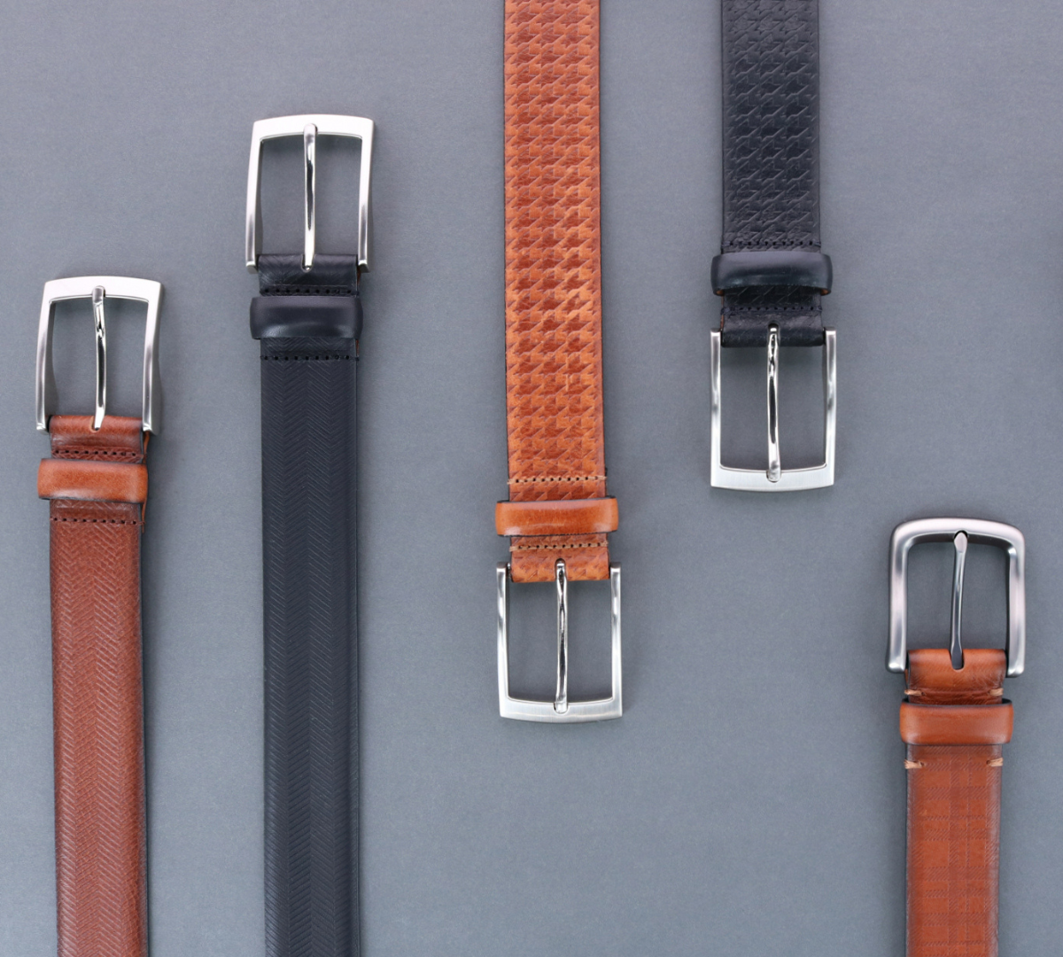 five embossed leather belts 