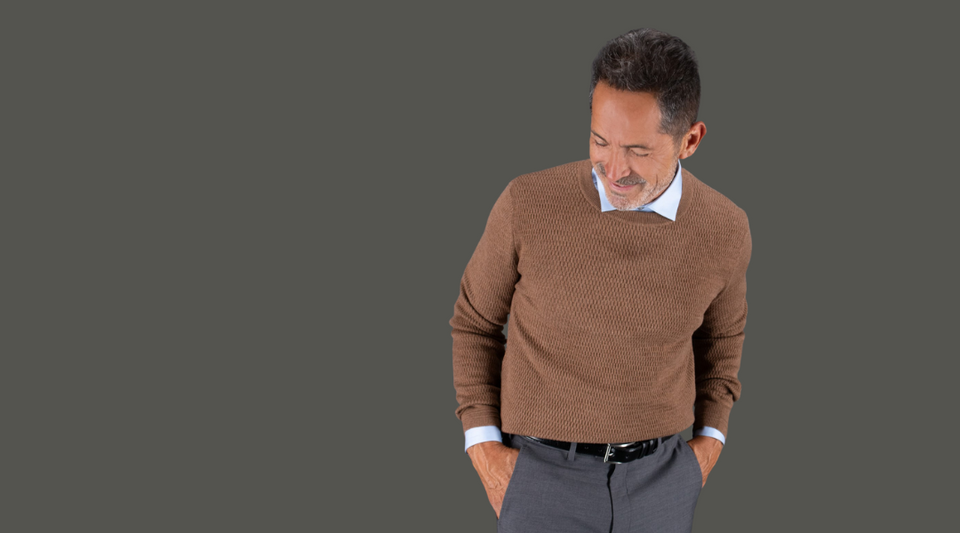 Man wearing brown sweater and leather belt with dress pants