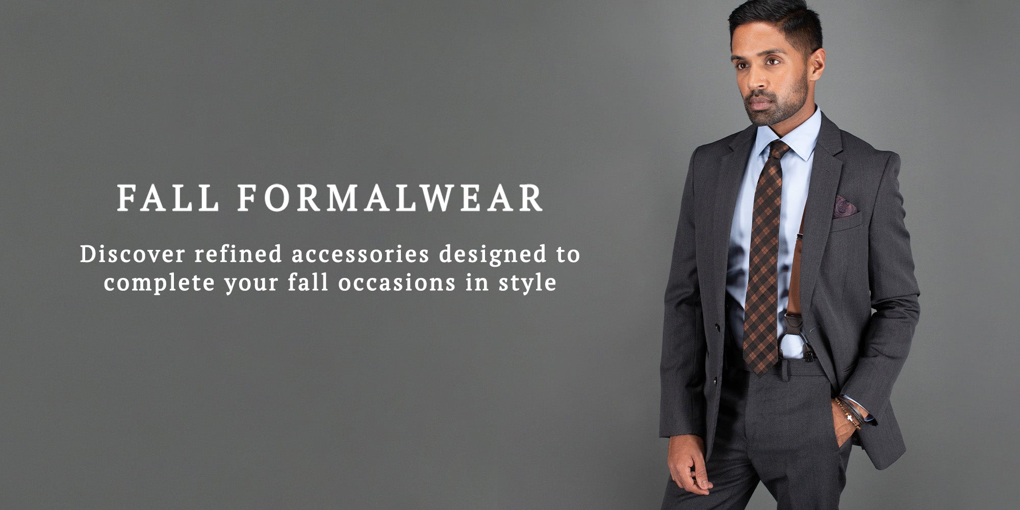 A man wearing a dark gray suit, light blue dress shirt, and a brown patterned tie stands against a solid gray background. Text on the left reads 'FALL FORMALWEAR' with a subtitle about refined accessories.