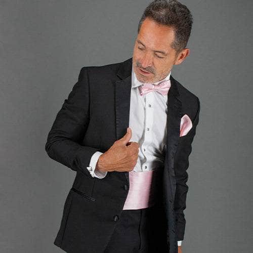 Man wearing a suit with the sutton collection bow tie, cummerbund, and pocket square